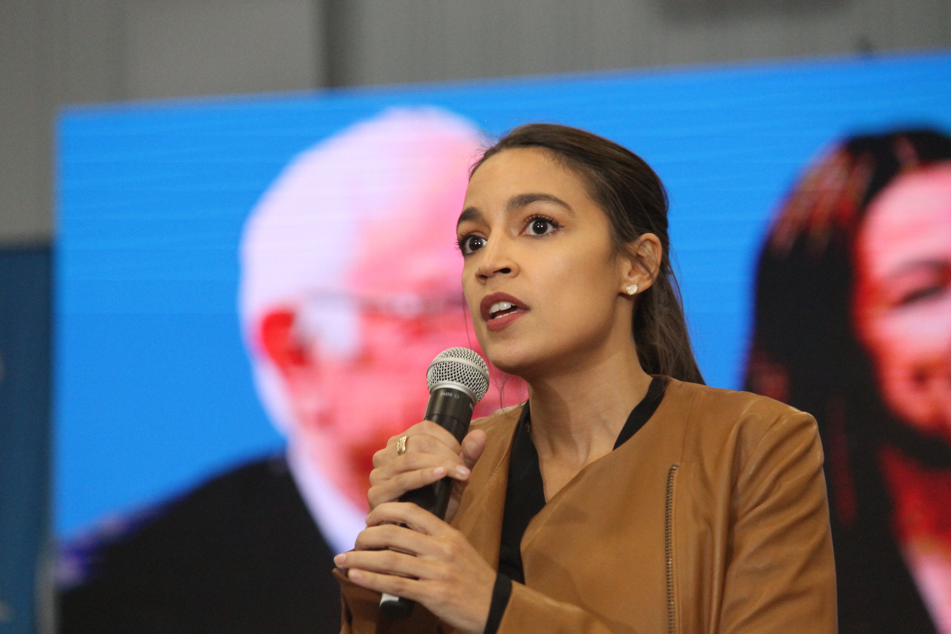 Rep. Alexandria Ocasio-Cortez speaking to attendees at a rally for Bernie Sanders in Council Bluffs, Iowa. - Matt A.J.